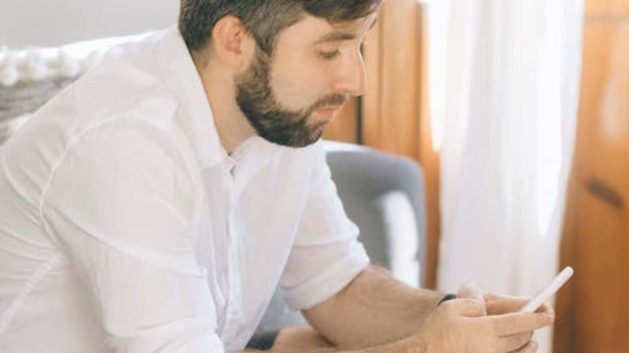Man closing private browser window, looking conflicted.