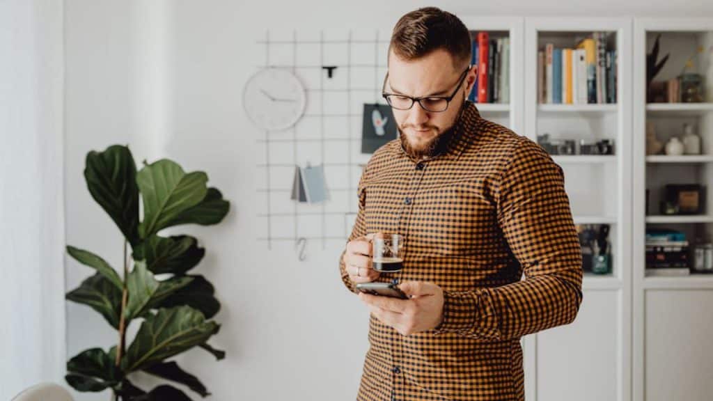 Man hesitating while reading a text, indicating emotional boundaries
