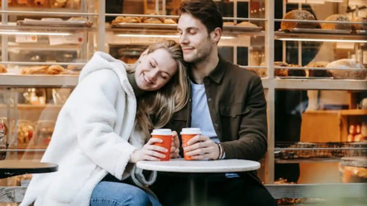 Couple sitting close, one partner gently reassuring the other.