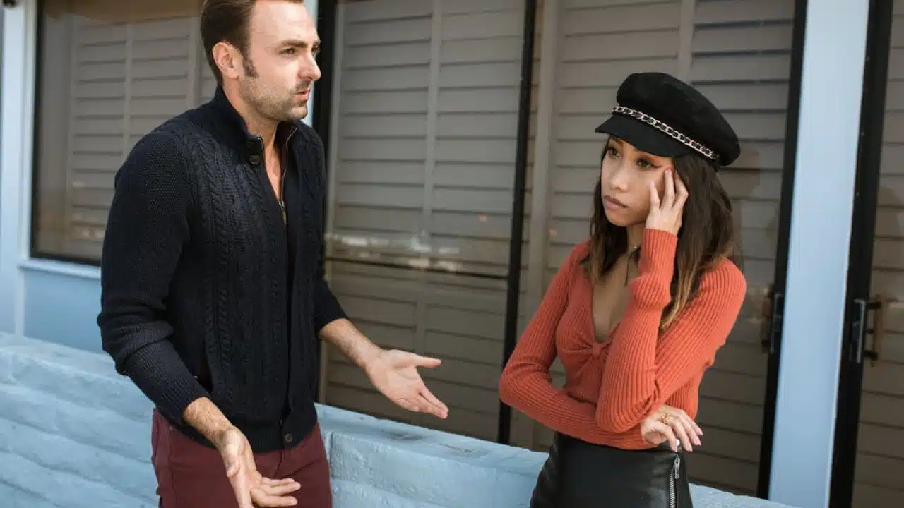 Man pausing a heated conversation, signaling need for space not control.