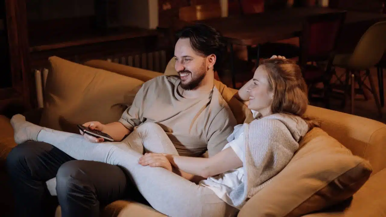 ©cottonbro studio/PexelsALT Text: A couple enjoying each other's company watching TV instead of going to the Cinema.