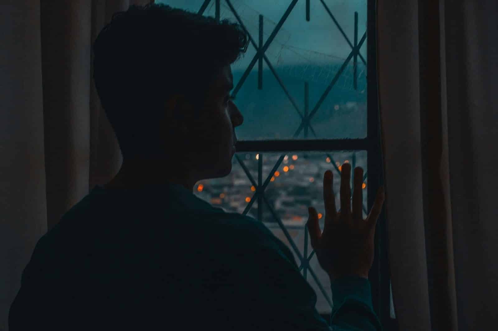 A man looking at the window.
