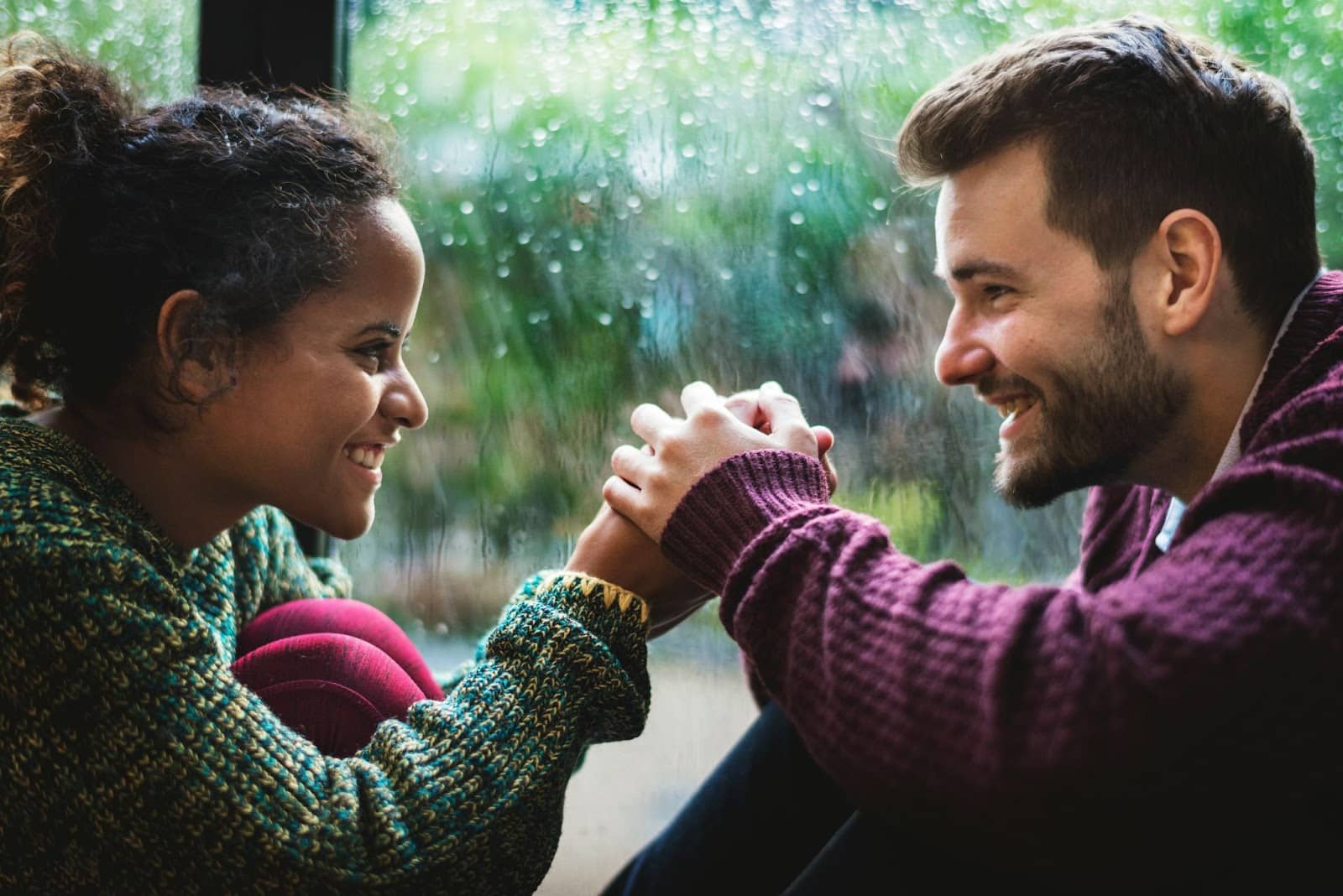 A man and woman holding hand and looking at each other.