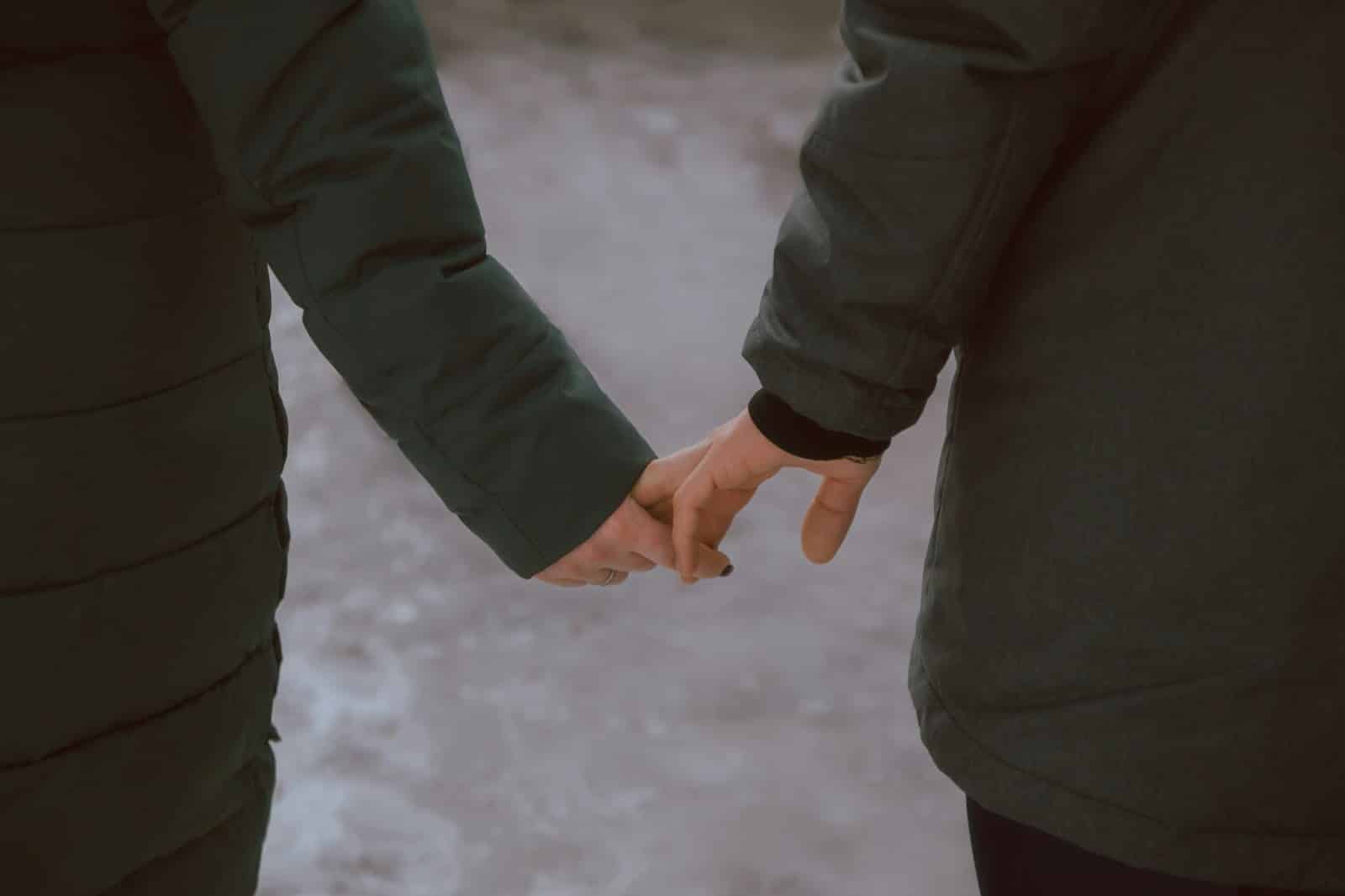 A couple holding hands.
