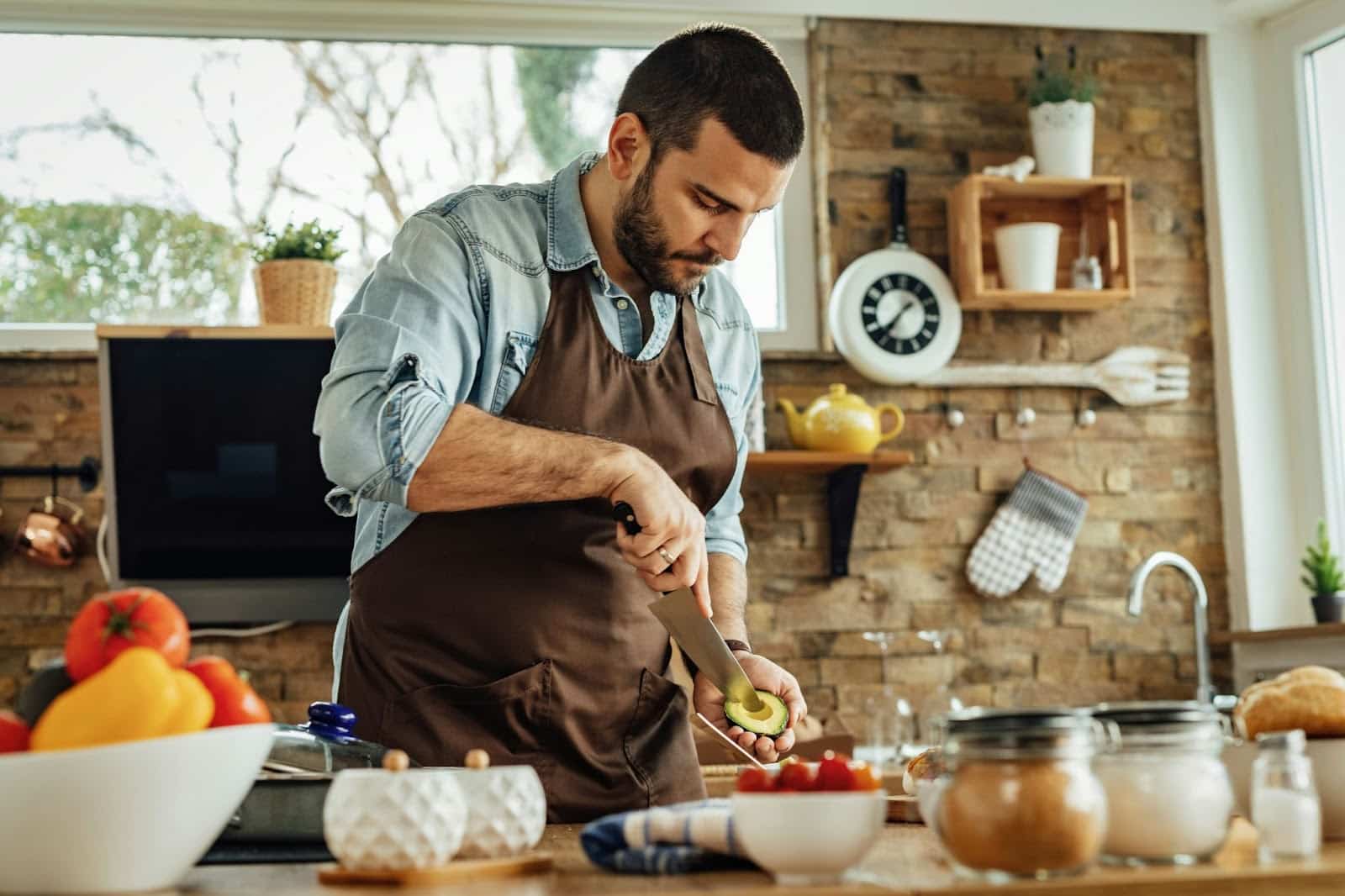 A man cutting an avocado.