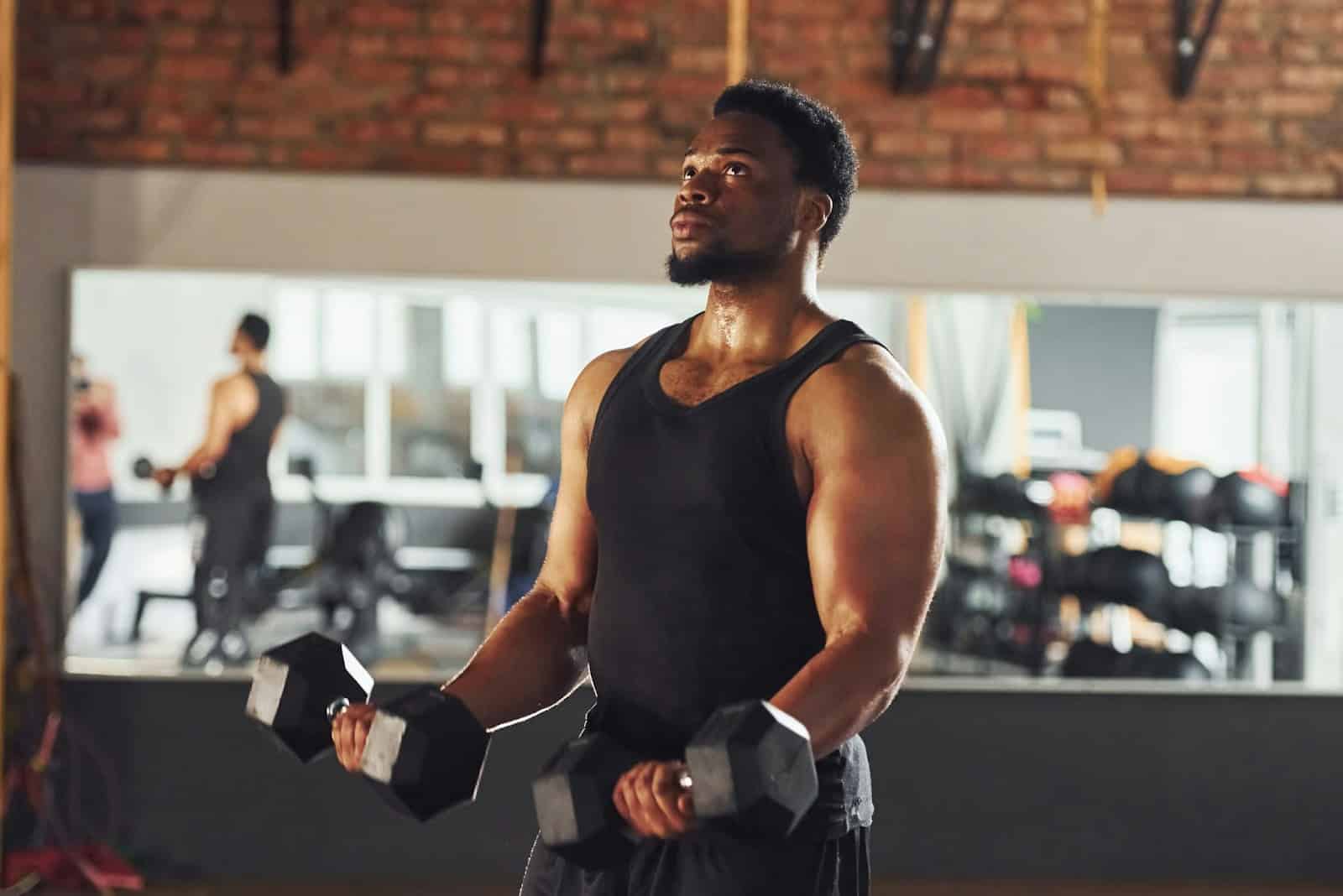 A man lifting a small barbell.