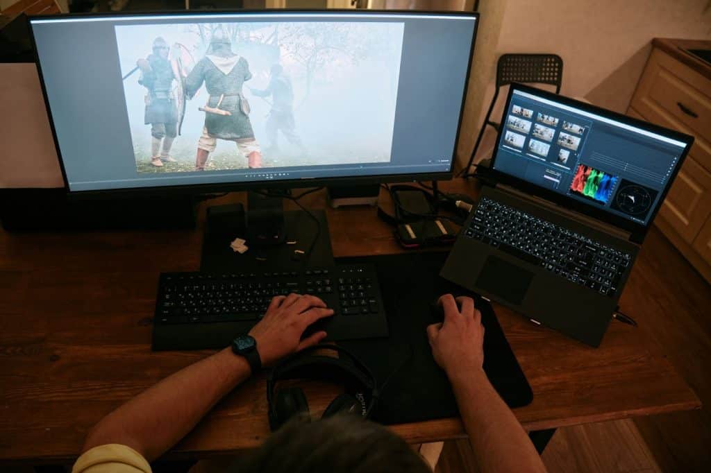 A person using a dual monitor for multi-tasking.
