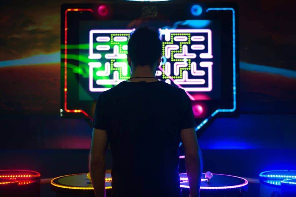 A man's back while he's playing a game.