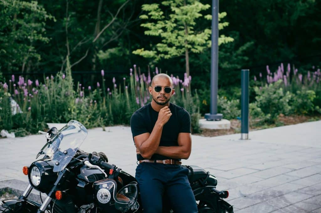 A man leaning at his motorcycle.
