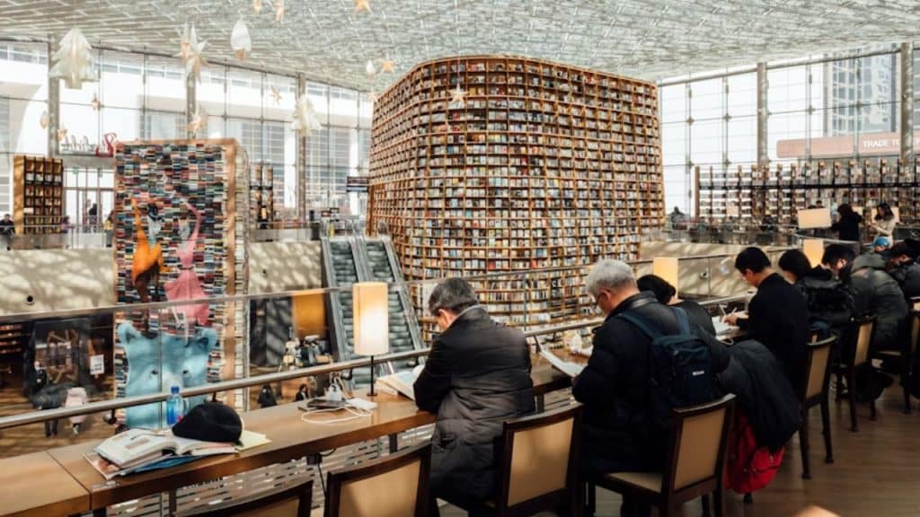 Group on men in a modern men’s book club relaxed setting.