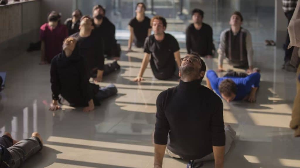 Small group of men practicing mindfulness indoors together.