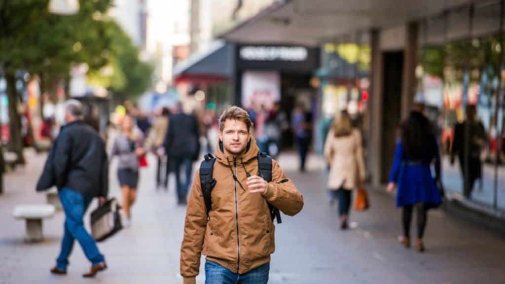 A self assured man walks through a modern city street, embodying emotional confidence.