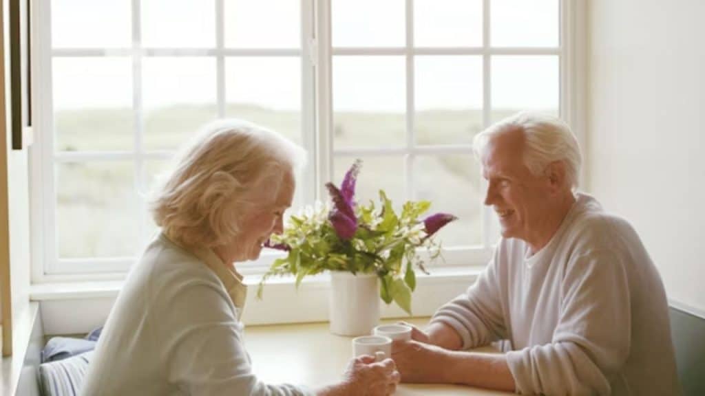 Older couple connecting over a personal conversation at a café.