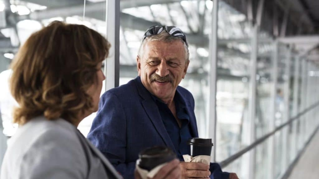 Mature man attentively listening to a woman during a date.