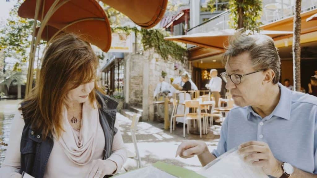 Older man and woman sharing a laugh during a casual date.