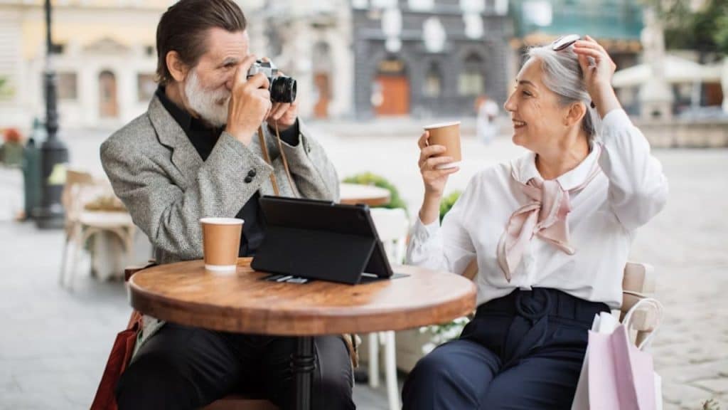 Older man and woman sharing a laugh during a casual date.