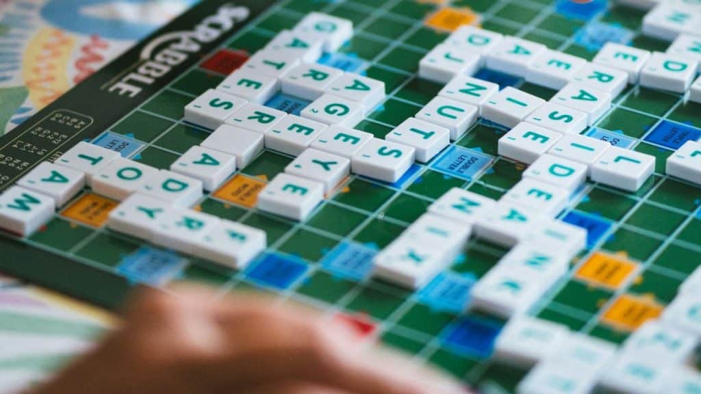 A close-up view of a Scrabble board with words formed from letter tiles.