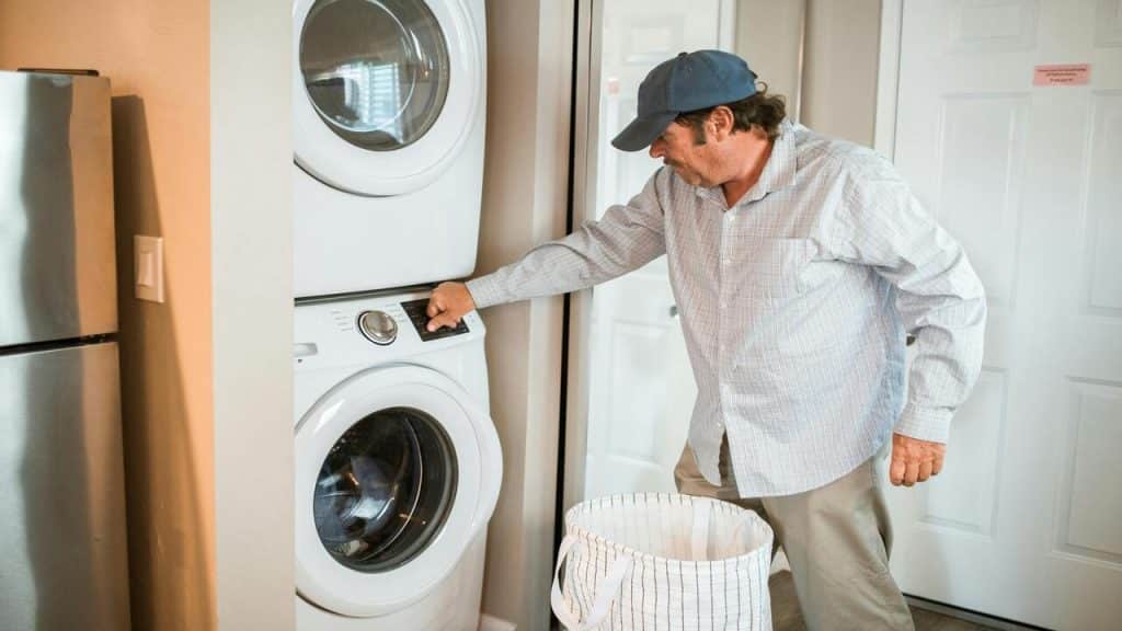 A man in a cap doing the laundry