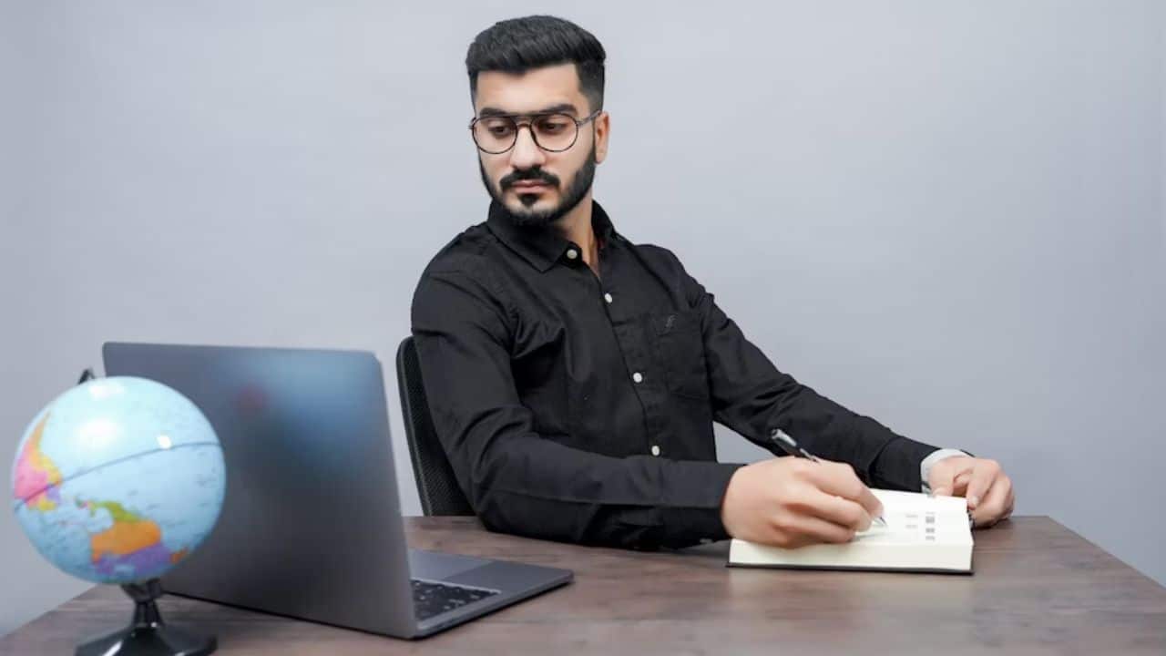 A man reading a book on cultural values at home.