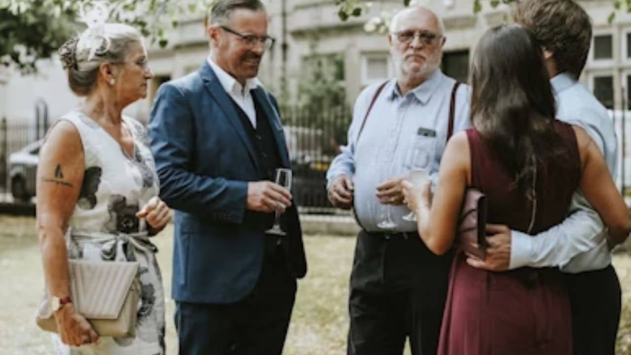 A couple nervously meeting their  partner’s family at a traditional gathering.