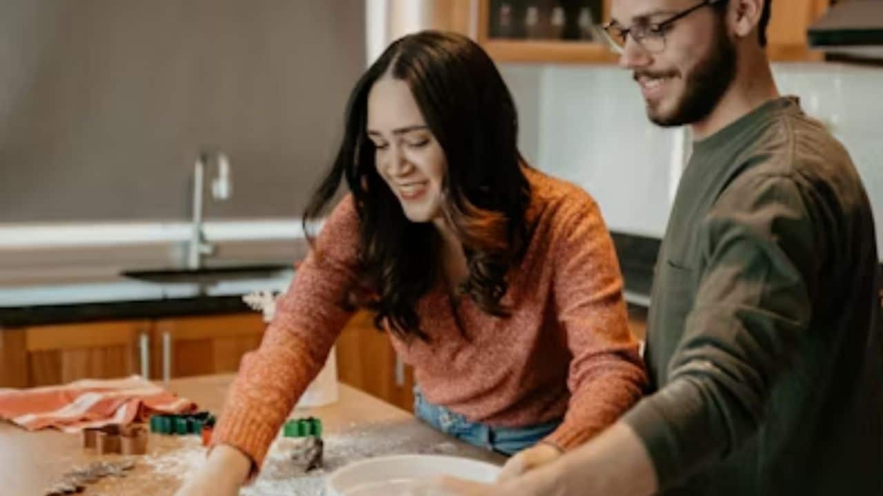 A couple cooking a traditional meal together.