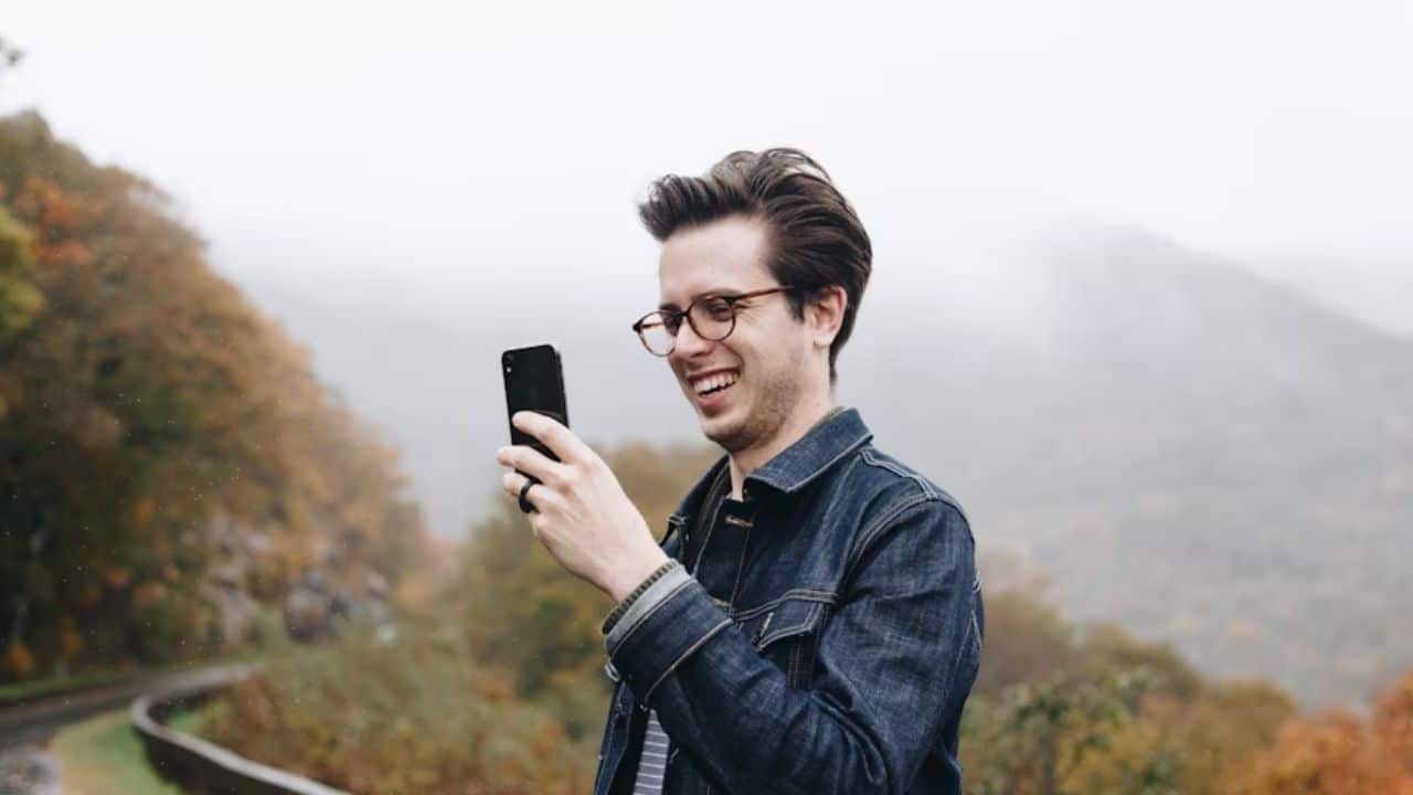 A man video calling his partner in another country.