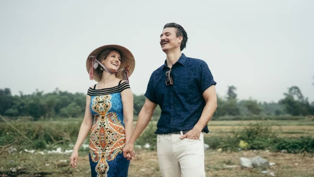 A couple smiling while traveling together.