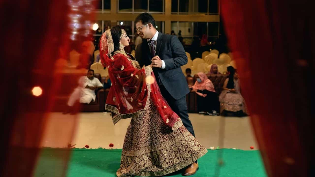 A multicultural couple dancing at their wedding.