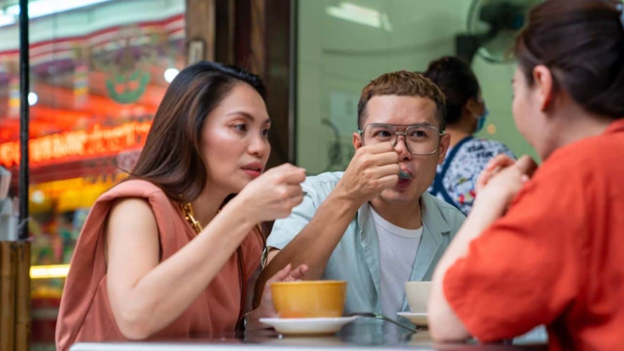 A couple facing judgmental stares from passersby.