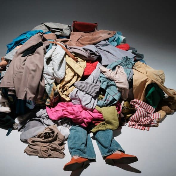 A pile of clothes covering a person