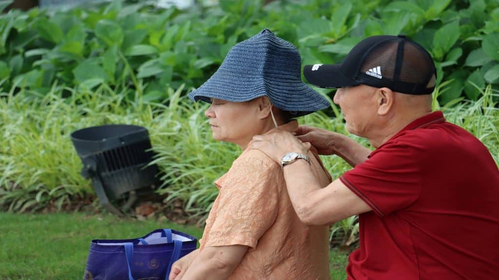 Husband massaging his wife’s shoulders.