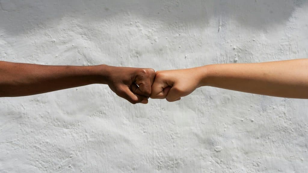 Two people bumping their fists together.
