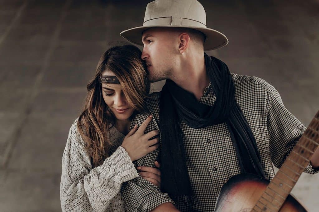A man kissing her girl on forehead