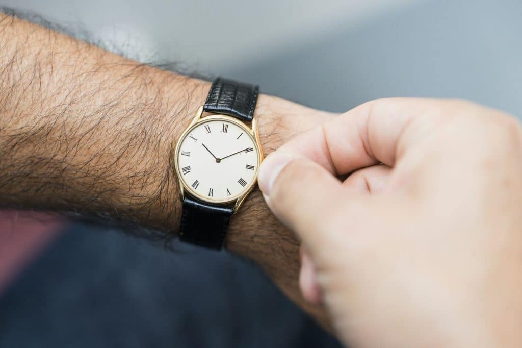 A person adjusting his watch