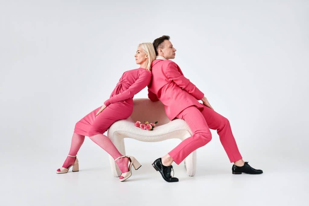 A couple seated facing away from each other