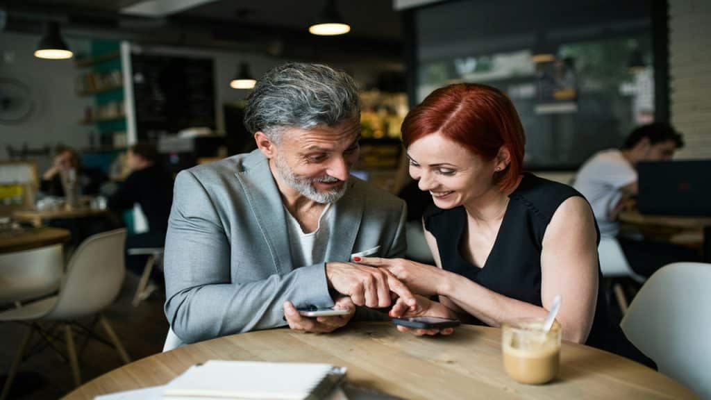A couple in a coffee shop sharing conversations.