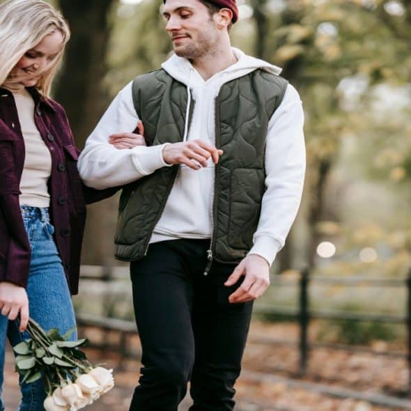 A married couple walking happily in the park.