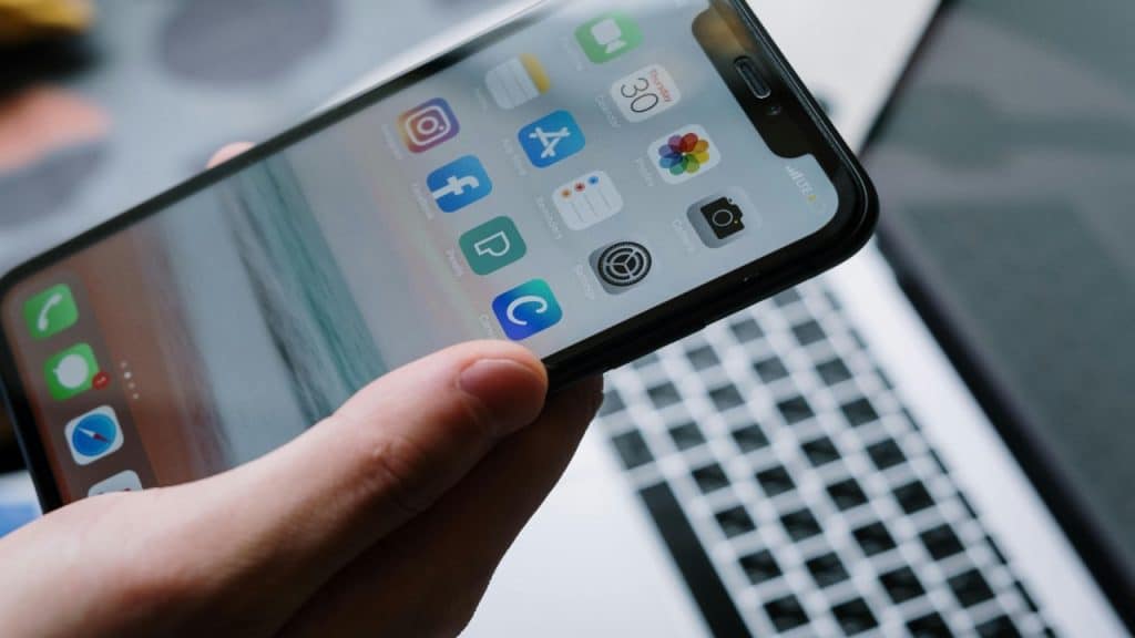 A man curates his digital presence while using an app, appearing intentional and focused.