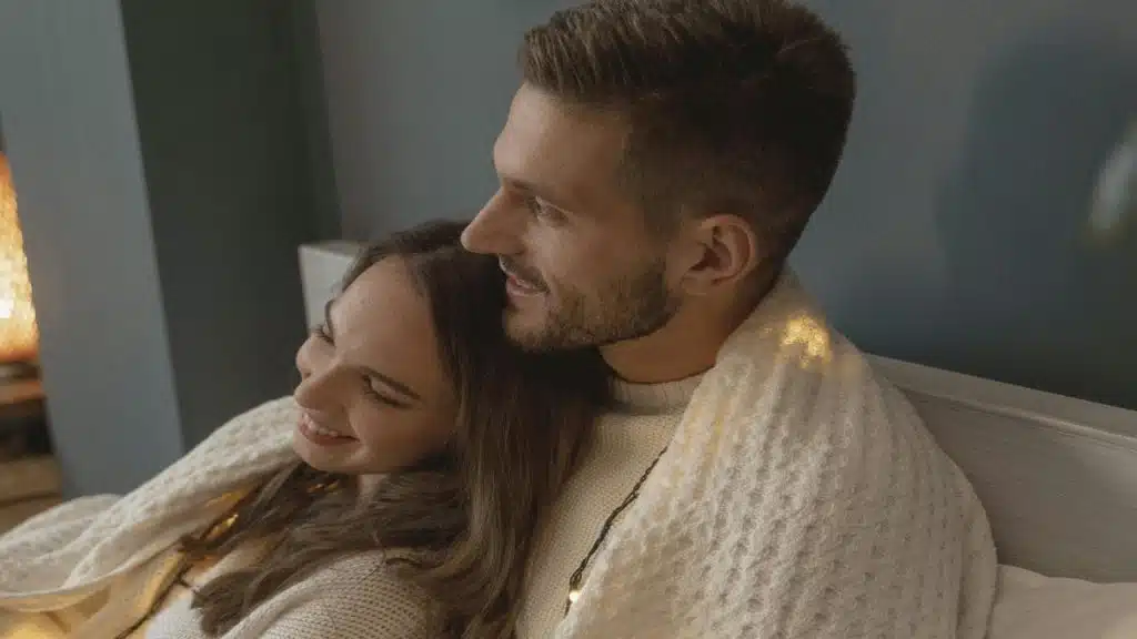 A couple sits in companionable silence, showing comfort and emotional connection without words.