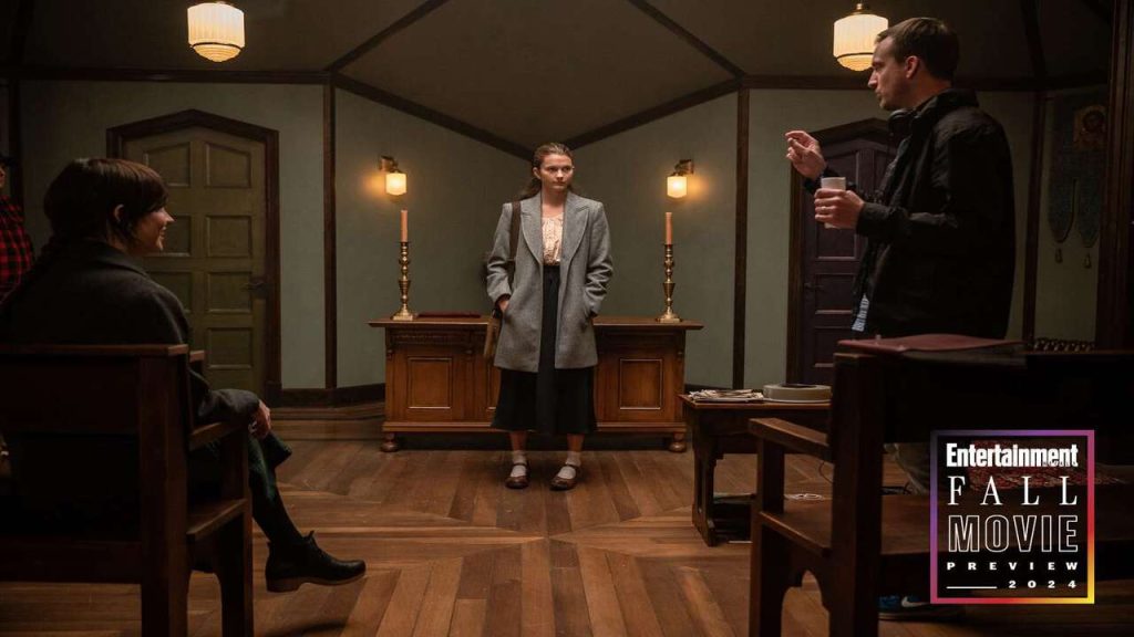 A woman and a man in the church being given directions by a director.