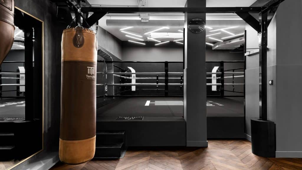 A boxing gym with a hanging punching bag