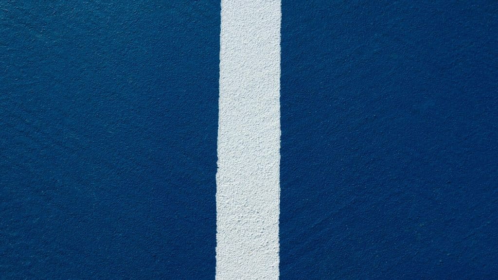 A white line painted on the side of a blue wall