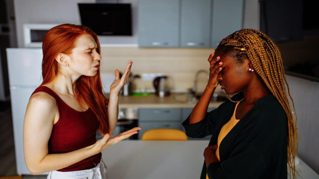 Two friends fighting in the kitchen