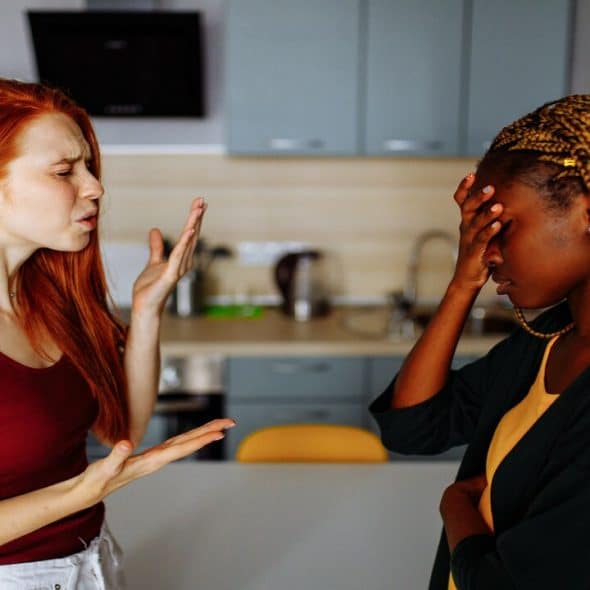 Two friends fighting in the kitchen
