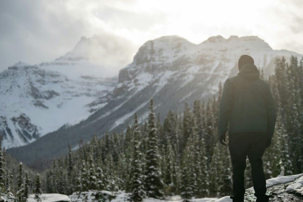 A man standing in front of a mountain