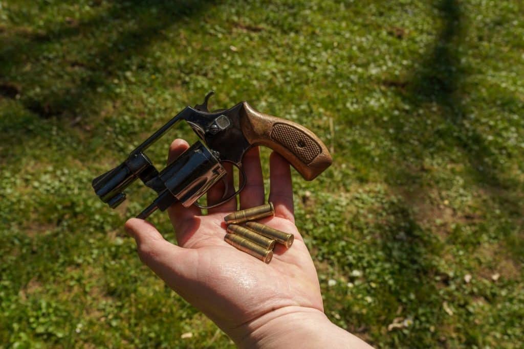 Man Holding a gun with bullets