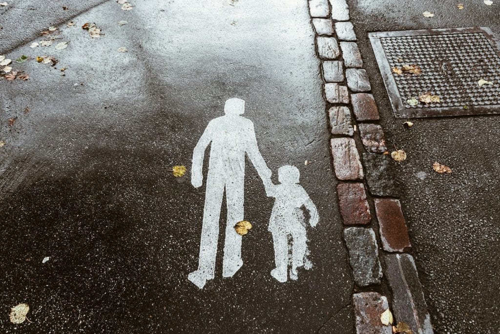 A picture of a drawing that represents man holding a kid