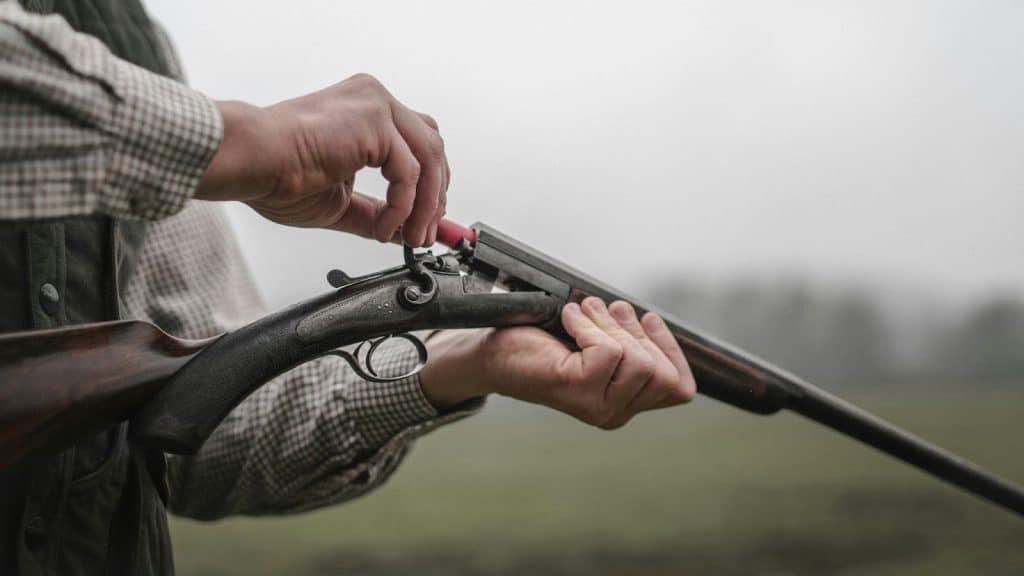 A man loading a gun 
