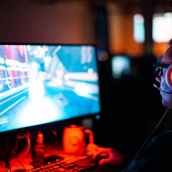 A picture of a guy playing pc games