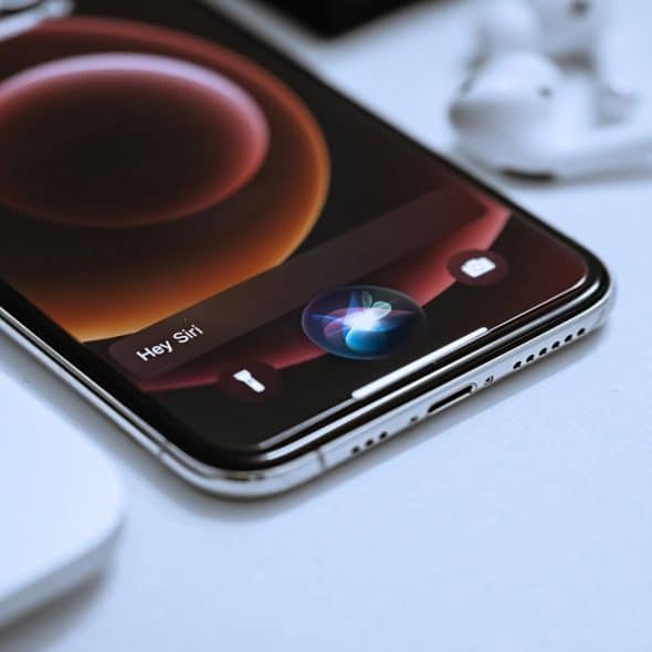 A close-up photo of a smartphone that sits on a white table.